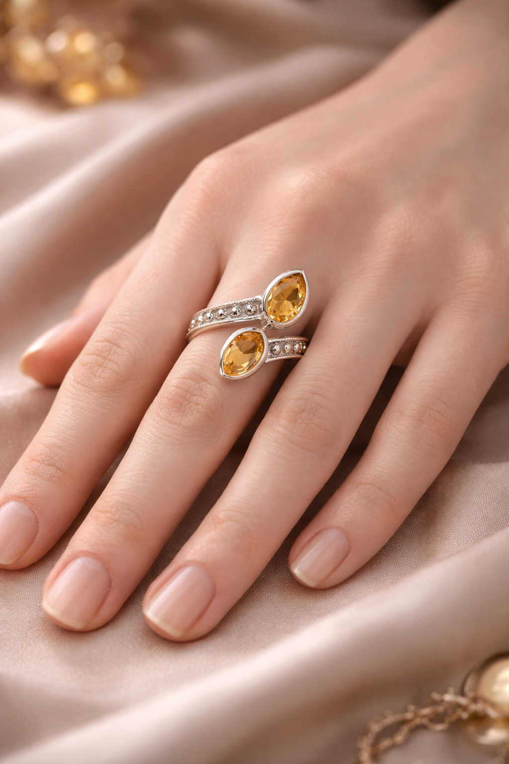 Bague Rayon Solaire en Citrine & Argent 925 portée sur le doigt, design double tour avec pierres citrine facetées et petits pavés brillants.