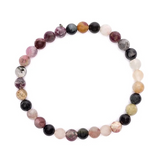 Bracelet en tourmaline naturelle multicolore, perles rondes alignées en arc, reflet énergies positives et équilibre.